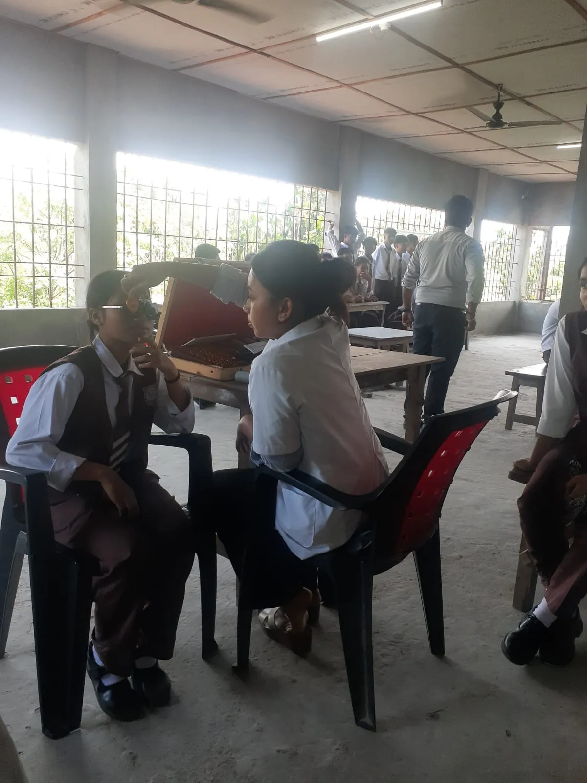 Diagnostic screening camp set up in rural school classrooms for pediatric eye care.